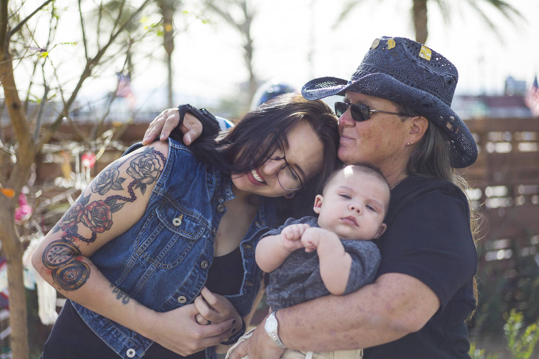 Oct. 1 shooting survivor Sue Ann Cornwell, right, holds infant Xander Finch whose mother Miriam Lujan, left, was rescued by Cornwell at the Route 91 festival. They reunited at the Community Healin ...