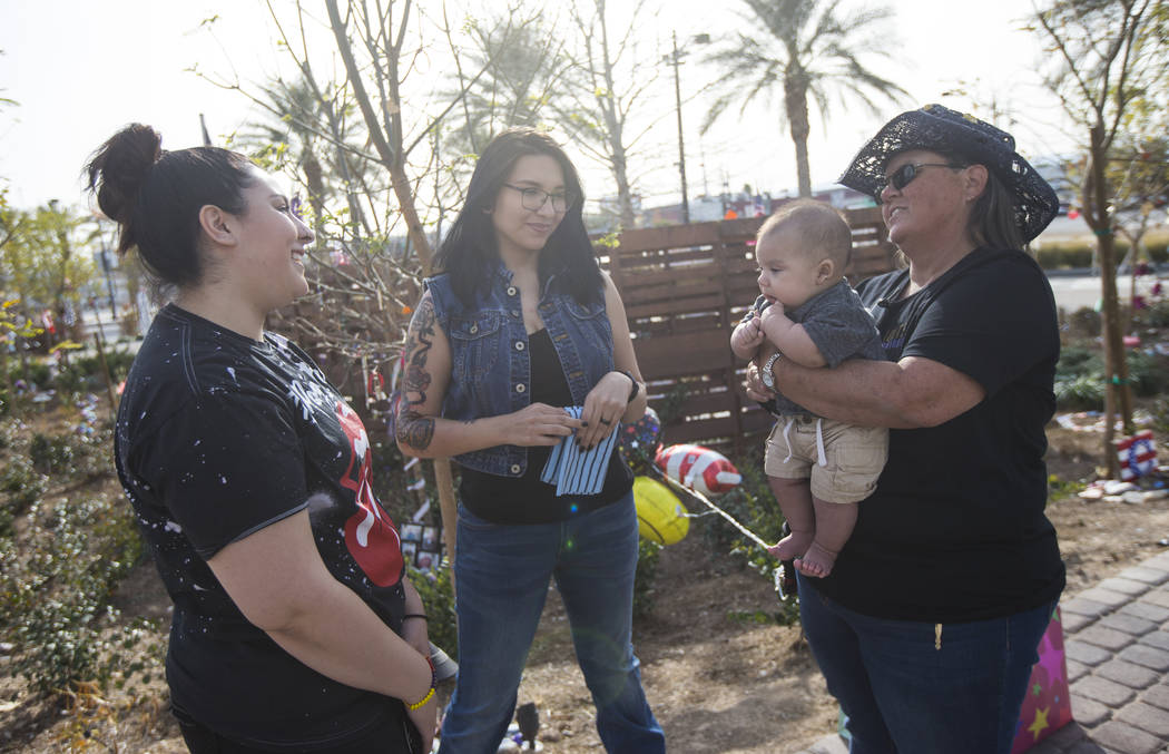 Oct. 1 shooting survivors, from left, Cynthia Velez, Miriam Lujan, and Sue Ann Cornwell, with infant Xander Finch whose mother Miriam Lujan, left, was rescued by Cornwell at the Route 91 festival, ...