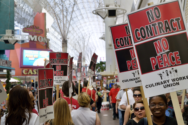 Culinary and Bartenders Union supporters picket at the Fremont Street Experience in downtown Las Vegas on April 12, 2014. The unions, which aren't officially on strike, staged the "informational p ...