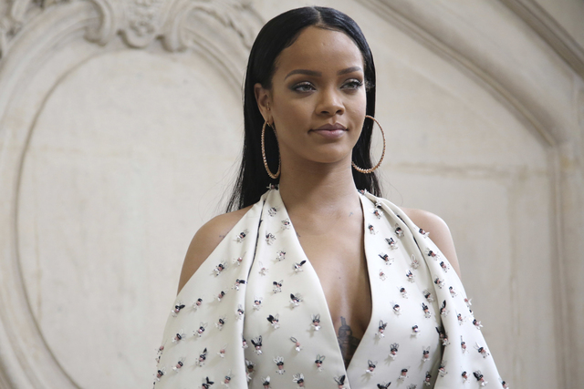 Singer Rihanna poses for photographers as she arrives to Christian Dior's Spring-Summer 2017 ready-to-wear fashion collection presented in Paris, Sept. 30, 2016. (AP Photo/Thibault Camus, File)