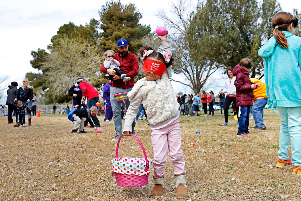Layla Stover, 4, of Las Vegas holds up a beeping egg during the Beepin' Egg Hunt at Sunset Park in Las Vegas, Saturday, March 24, 2018. Nevada Blind Children's Foundation hosted the egg hunt for v ...