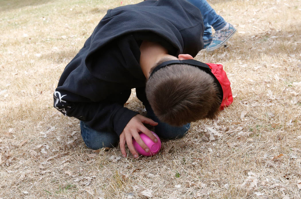 Johnny Gonzales Lamb, 11, of Las Vegas with a blindfold listens to a beeping egg during the Beepin' Egg Hunt at Sunset Park in Las Vegas, Saturday, March 24, 2018. Nevada Blind Children's Foundati ...