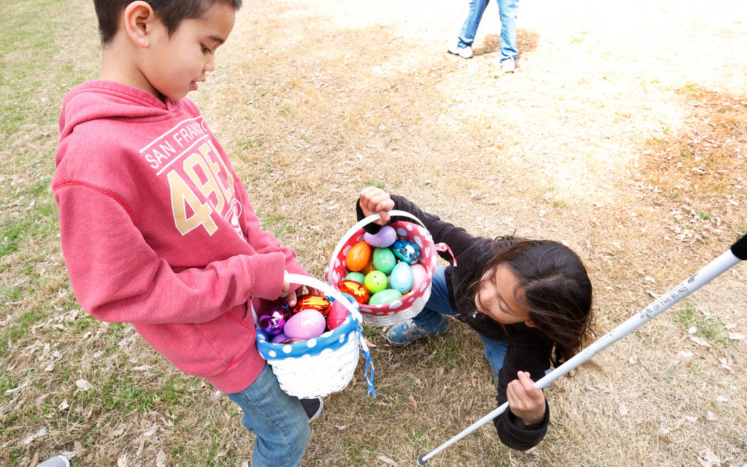 Las Vegas resident Marley Rupp, 8 with visual impairment shows her Easter basket to her brother Jackson, 6, after the Beepin' Egg Hunt at Sunset Park in Las Vegas, Saturday, March 24, 2018. Nevada ...