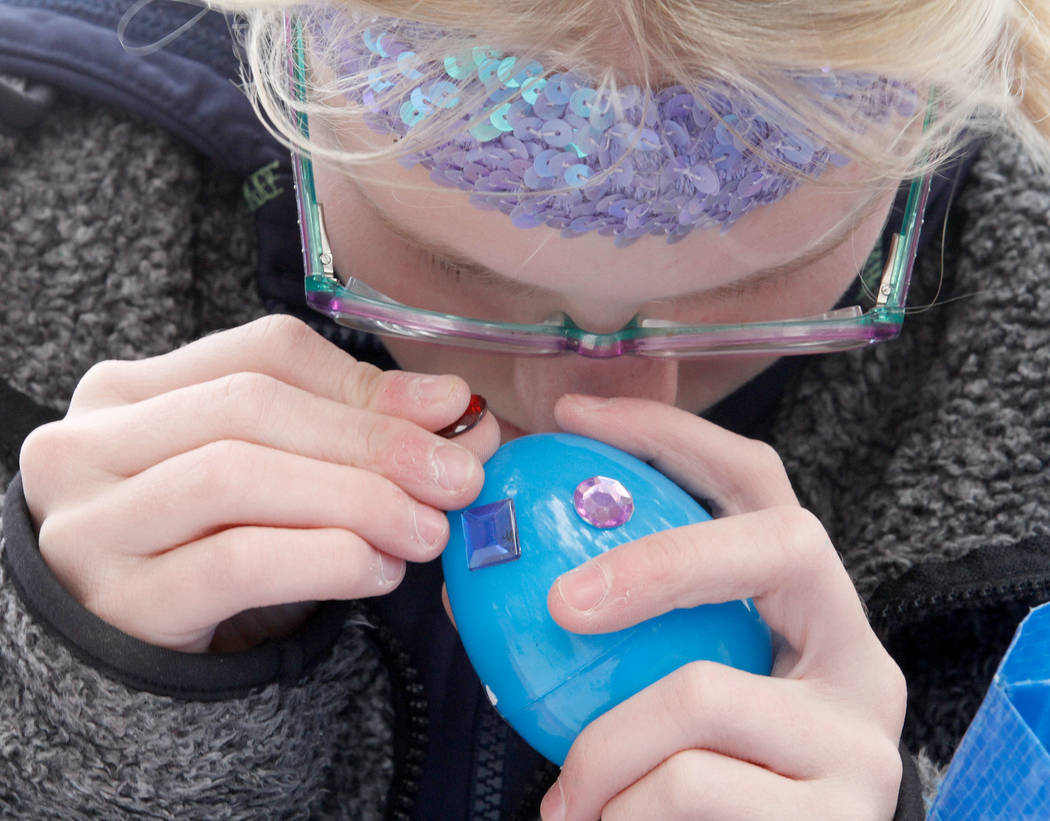 Kristlynn Allison, 10, of Las Vegas decorates an Easter egg before the Beepin' Egg Hunt at Sunset Park in Las Vegas, Saturday, March 24, 2018. Nevada Blind Children's Foundation hosted the egg hun ...