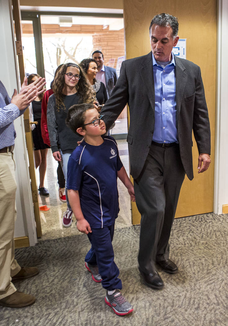 Danny Tarkanian walks in to file for his candidacy for the 3rd Congressional District of Nevada with his son, Jerry Tarkanian Jr., at the Clark County Government Center in Las Vegas on Friday, Mar ...