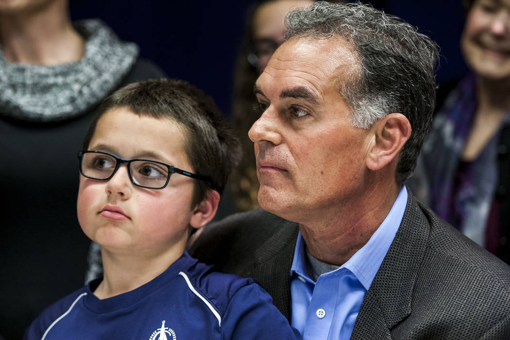 Danny Tarkanian files for his candidacy for the 3rd Congressional District of Nevada with his son, Jerry Tarkanian Jr., on his lap at the Clark County Government Center in Las Vegas on Friday, Mar ...