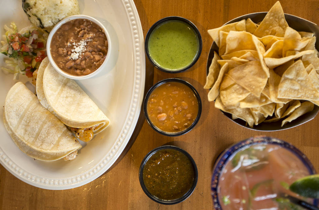 The award winning queso and shrimp tacos served with a chips and salsa trio and the award winning guava picosa jalapeno margarita at Leticia's Mexican Cocina located at Tivoli Village at Queensrid ...