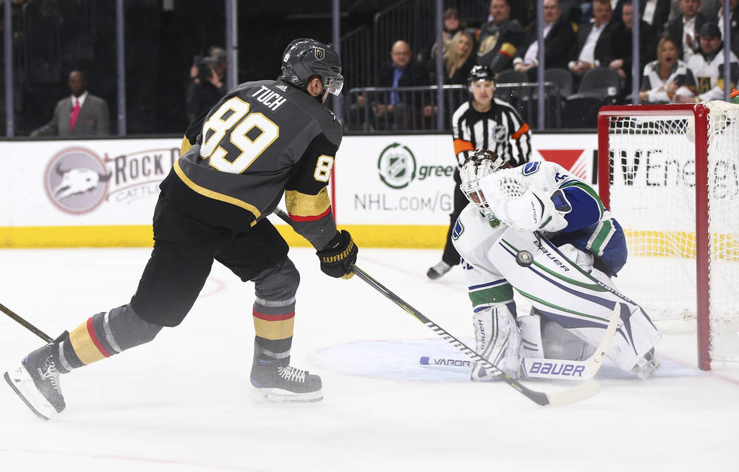 Golden Knights right wing Alex Tuch (89) attempts to score as Vancouver Canucks goaltender Jacob Markstrom (25) defends during the first period of an NHL hockey game at T-Mobile Arena in Las Vegas ...