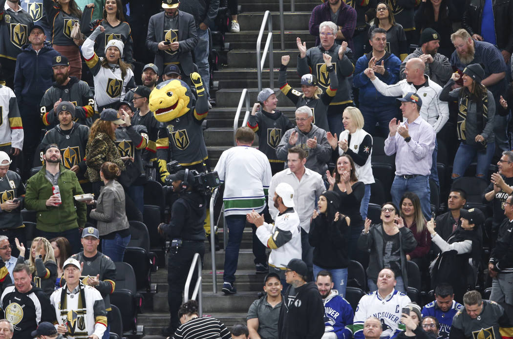 Golden Knights fans celebrate goal by left wing Tomas Tatar, not pictured, during the second period of an NHL hockey game against the Vancouver Canucks at T-Mobile Arena in Las Vegas on Tuesday, M ...