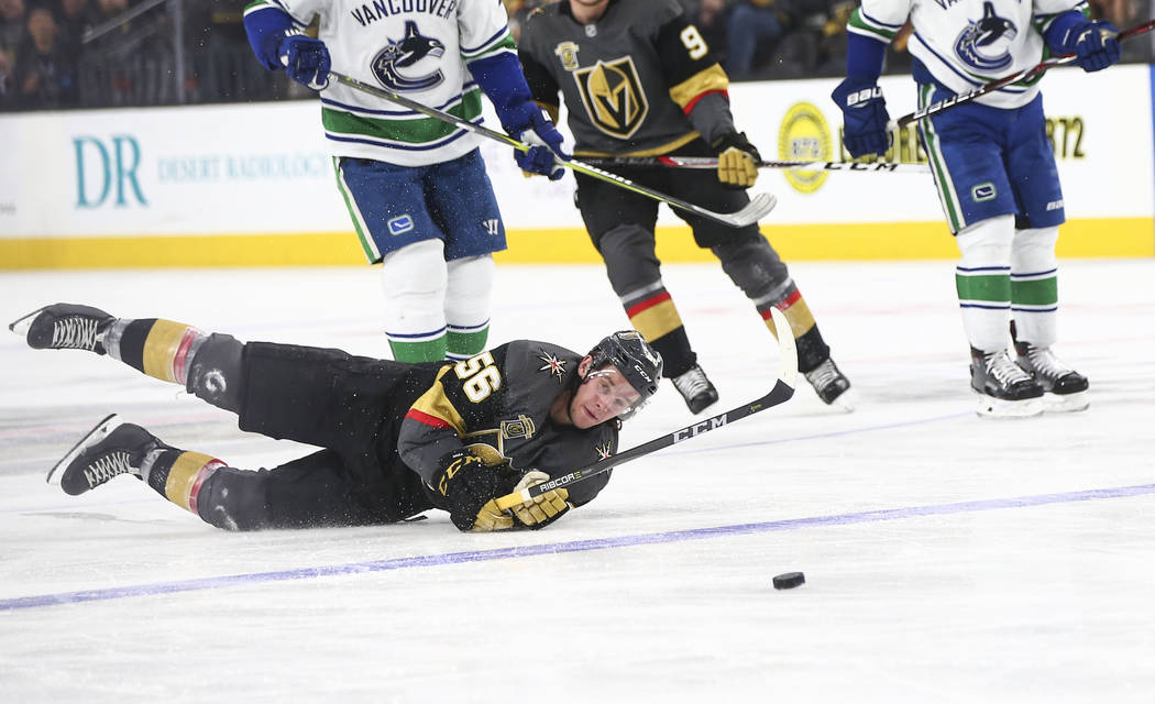 Golden Knights left wing Erik Haula (56) gets tripped up by Vancouver Canucks defenseman Alexander Edler, not pictured, during the third period of an NHL hockey game at T-Mobile Arena in Las Vegas ...