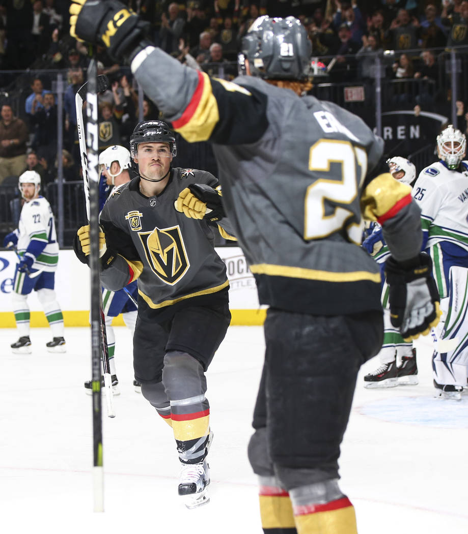 Golden Knights center Ryan Carpenter, left, reacts after a goal by Golden Knights center Cody Eakin (21) during the first period of an NHL hockey game at T-Mobile Arena in Las Vegas on Tuesday, Ma ...