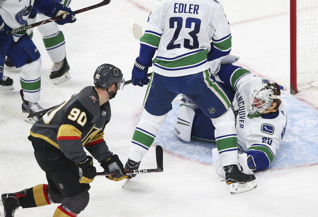 Golden Knights left wing Tomas Tatar (90) scores against Vancouver Canucks goaltender Jacob Markstrom (25) during the second period of an NHL hockey game against the Vancouver Canucks at T-Mobile  ...