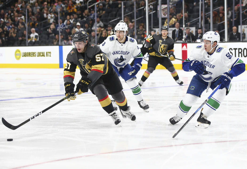 Golden Knights left wing David Perron (57) controls the puck against Vancouver Canucks defenseman Troy Stecher (51) during the third period of an NHL hockey game at T-Mobile Arena in Las Vegas on  ...