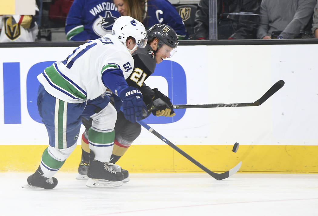 Golden Knights center Cody Eakin (21) controls the puck against Vancouver Canucks defenseman Troy Stecher (51) during the third period of an NHL hockey game at T-Mobile Arena in Las Vegas on Tuesd ...