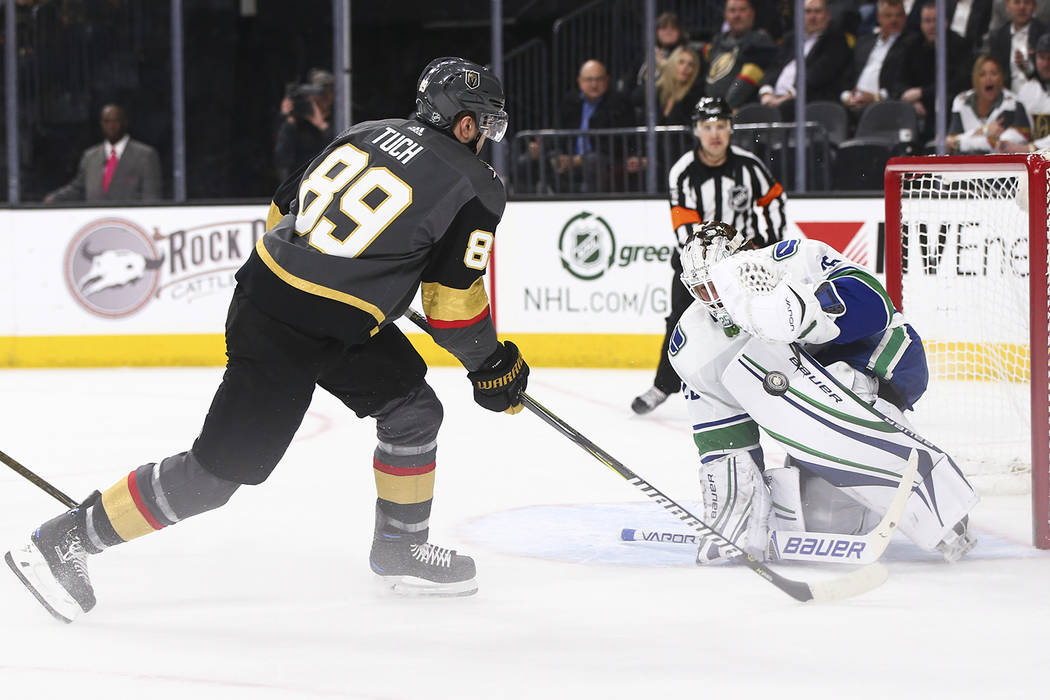 Golden Knights right wing Alex Tuch (89) attempts to score as Vancouver Canucks goaltender Jacob Markstrom (25) defends during the first period of an NHL hockey game at T-Mobile Arena in Las Vegas ...
