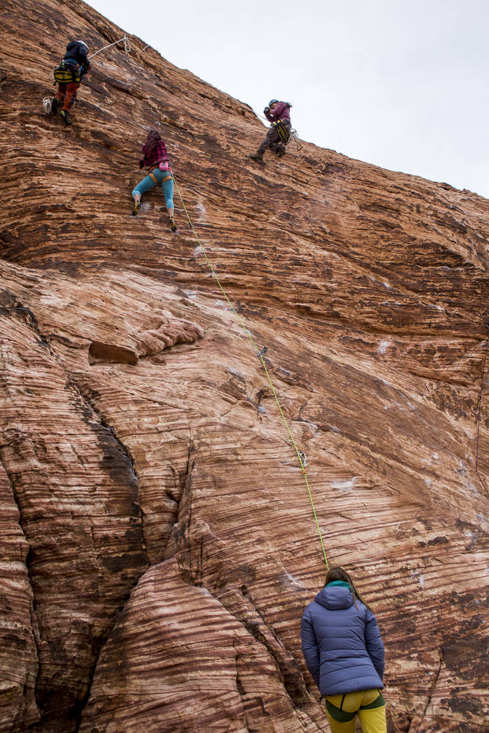 Climbers ascend a rock face while William Pham of San Diego, Calif., third from left, takes photos at Calico Basin during Red Rock Rendezvous on Saturday, March 17, 2018.  Patrick Connolly Las Veg ...