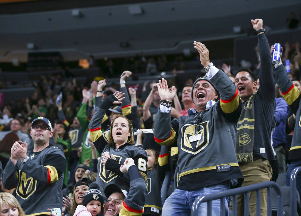 Golden Knights fans celebrate the team's first goal against the New Jersey Devils during the second period of an NHL hockey game at T-Mobile Arena in Las Vegas on Wednesday, March 14, 2018. Chase  ...