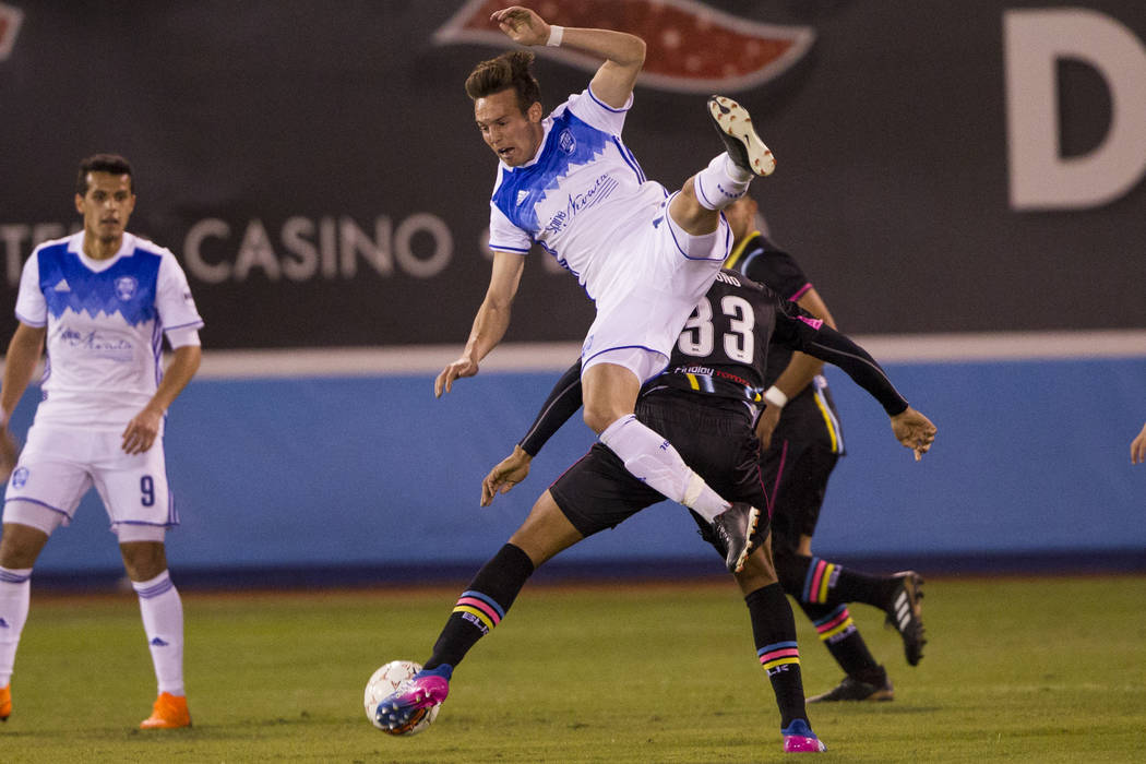 Reno 1868 FC’s Danny Musovski (12) goes for the ball against Las Vegas Lights FC’s  Miguel Angel Gardun~o (33) in the first half of the United Soccer League game at Cashman Field in  ...