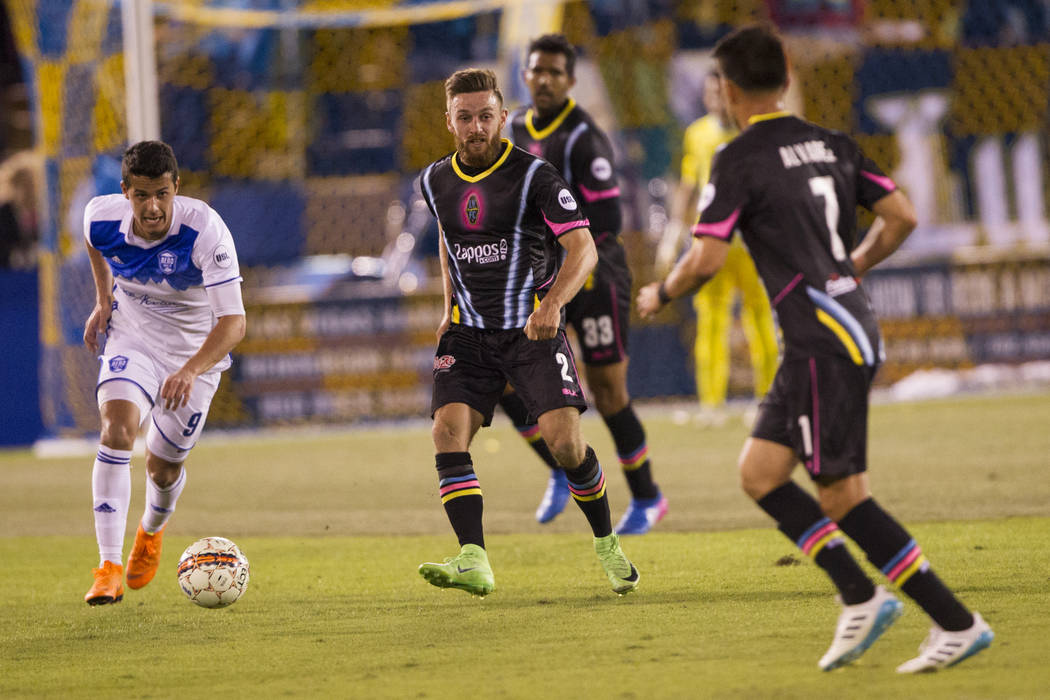 Las Vegas Lights FC’s Zak Drake (2) makes a pass under pressure from Reno 1868 FC’s Mark Gonzalez (9)  during the second half of the United Soccer League game at Cashman Field in Las ...