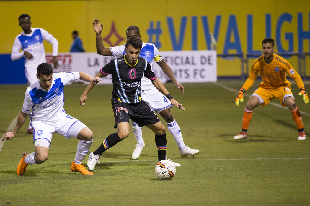 Las Vegas Lights FC’s Carlos Alvarez (7) goes for the ball against Reno 1868 FC’s Mark Gonzalez (9) during the second half of the United Soccer League game at Cashman Field in Las Ve ...