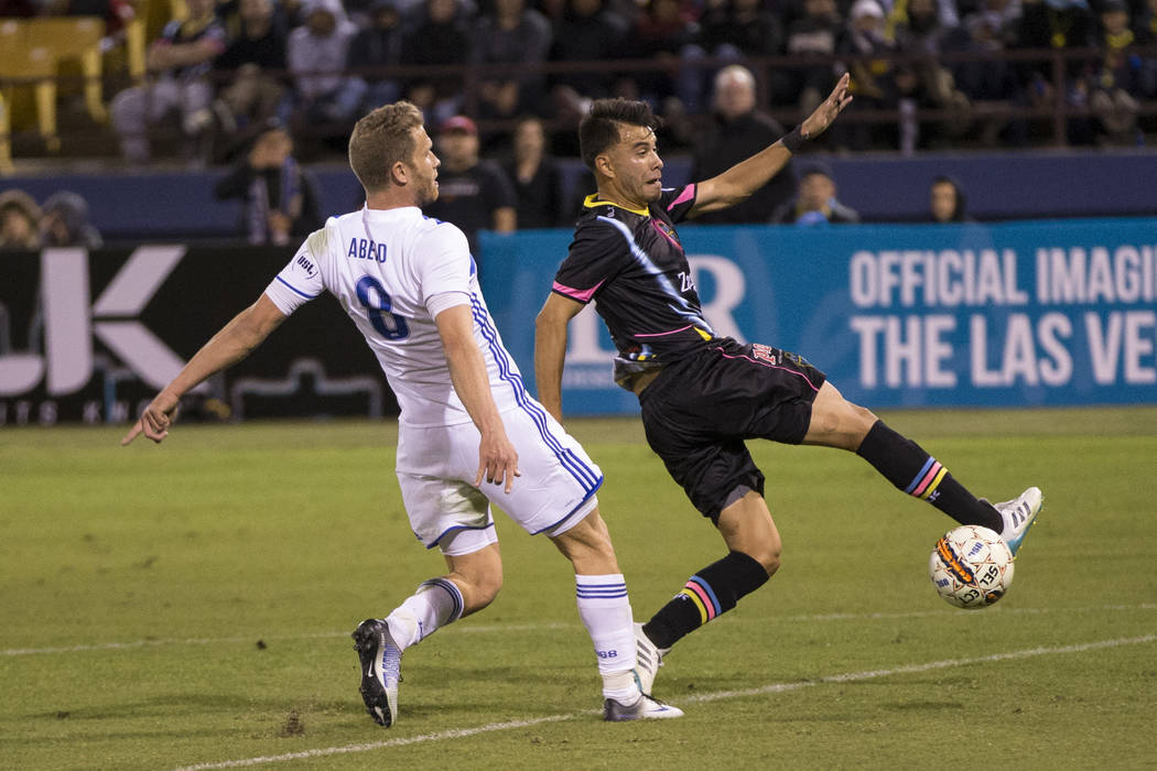 Las Vegas Lights FC’s Carlos Alvarez (7) goes for the ball against Reno 1868 FC’s Guy Abend (8) during the second half of the United Soccer League game at Cashman Field in Las Vegas, ...