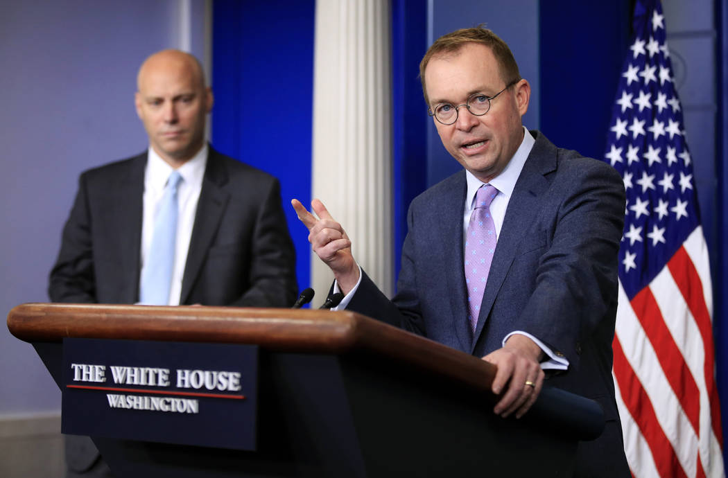 Office of Management and Budget Director Mick Mulvaney, right, with White House Director of Legislative Affairs and Assistant Marc Short, talks to reporters in the Brady press briefing room at the ...