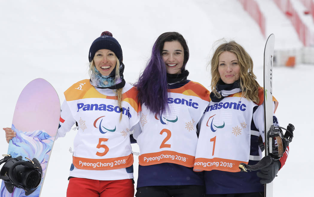 Gold medal winner Brenna Huckaby of the United States, center, silver medalist Cecile Hernandez of France, left, and bronze medalist Amy Purdy of the United States pose for the media during the vi ...