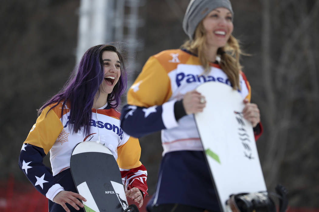 Winners of the Women's Snowboard Cross SB-LL1 event from left gold medalist Brenna Huckaby of United States and silver medalist Amy Purdy of United States react during a ceremony at the 2018 Winte ...