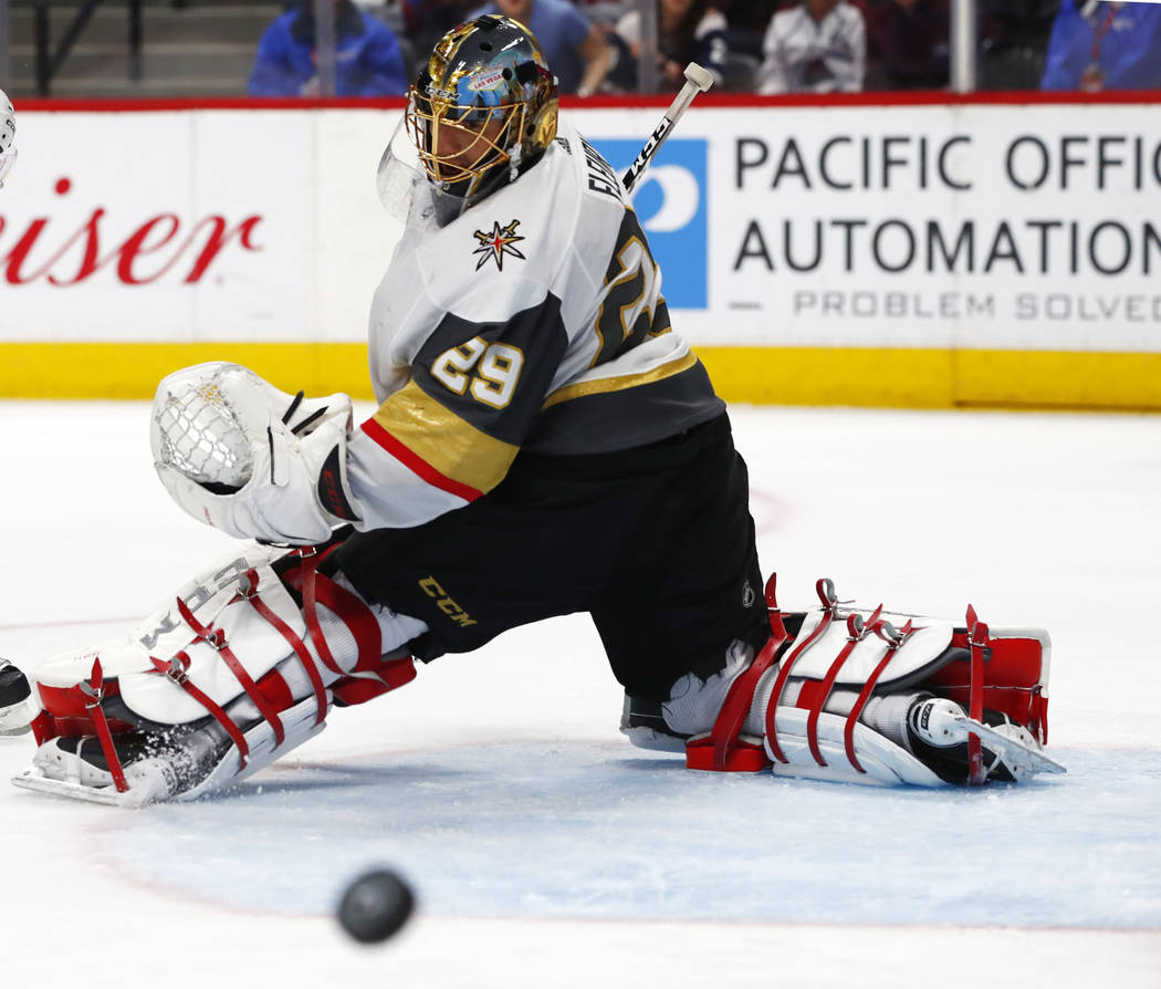 Vegas Golden Knights goaltender Marc-Andre Fleury follows the flight of the puck after deflecting a shot against the Colorado Avalanche in the third period of an NHL hockey game Saturday, March 24 ...
