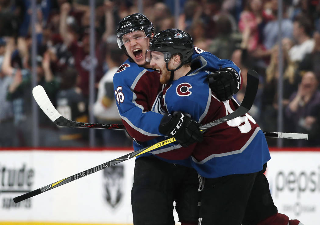 Colorado Avalanche right wing Mikko Rantanen, left, congratulates left wing Gabriel Landeskog after he scored the winning goal against Vegas Golden Knights in the shootout session of an NHL hockey ...