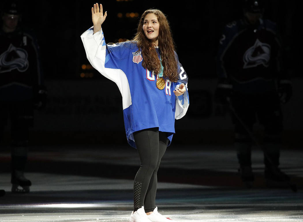 United States gold medal winning olympic hockey player Nicole Hensley of Littleton, Colo., waves to the crowd as she is introduced before taking part in a ceremonial puck drop before the Colorado  ...