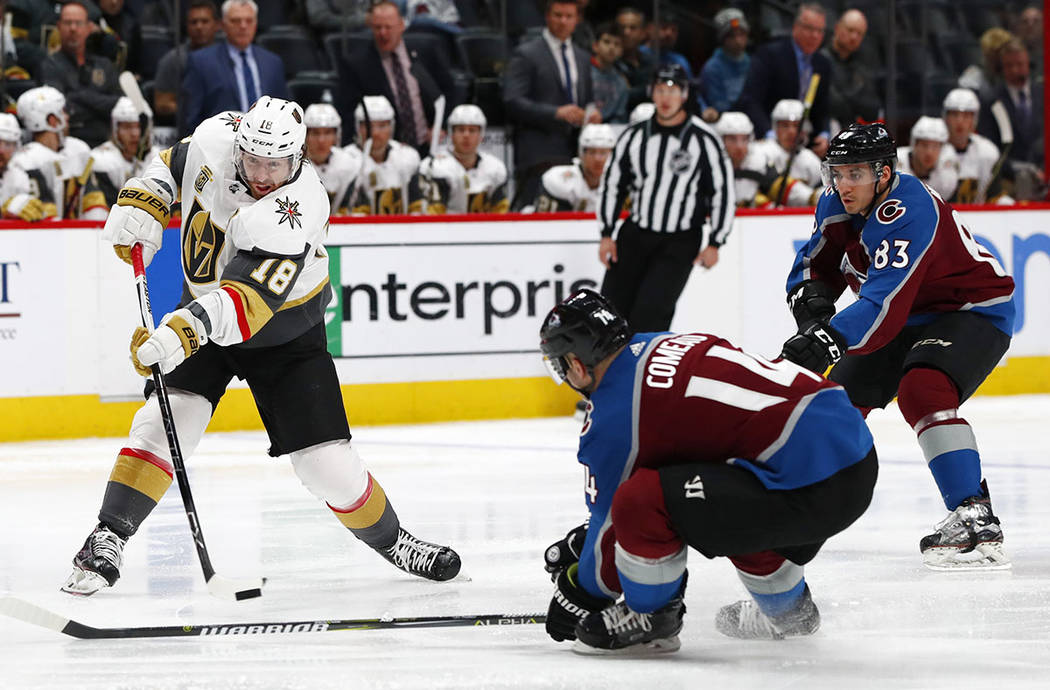 Vegas Golden Knights left wing James Neal, left, unleashes a shot as Colorado Avalanche left wing Blake Comeau, front right, and left wing Matt Nieto defend in the second period of an NHL hockey g ...
