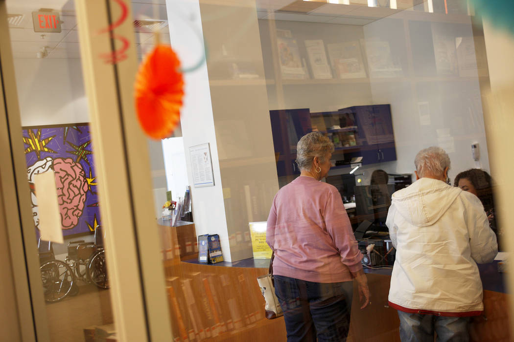 Visitors speaks to the receptionist at the lobby at the Cleveland Clinic in Las Vegas, Monday, March 26, 2018. A new study released Tuesday by the Alzheimer's Association reports that Nevada will  ...