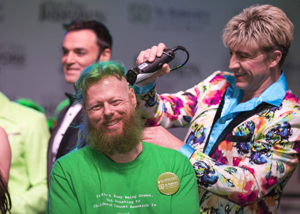 Ed Conte, a crew member for Cirque du Soleil's Zumanity, gets his head shaved during the St. Baldrick's head-shaving event to raise money for childhood cancer research outside the New York-New Yor ...