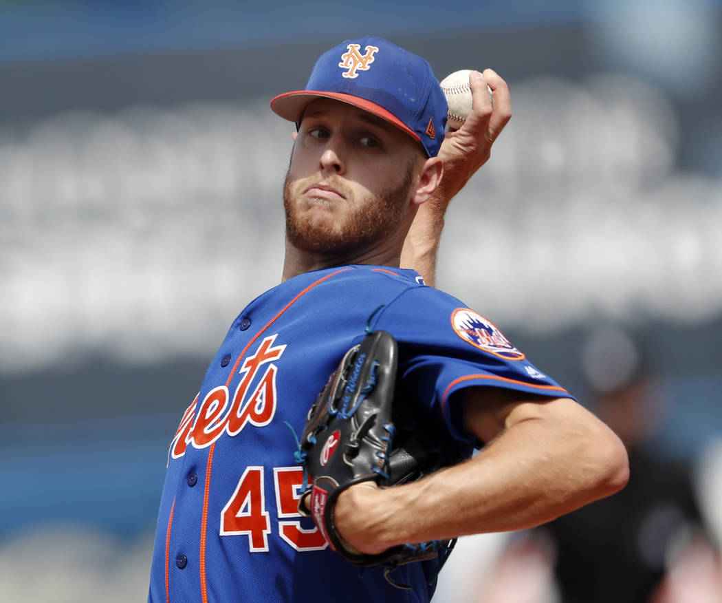 FILE - In this March 7, 2018, file photo, New York Mets starting pitcher Zack Wheeler warms up before the first inning of a spring training baseball game against the New York Yankees in Port St. L ...