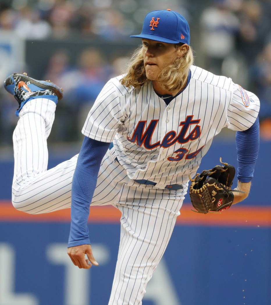 New York Mets starting pitcher Noah Syndergaard (34) follows through on a pitch during the first inning of an opening day baseball game against the St. Louis Cardinals, Thursday, March 29, 2018, i ...