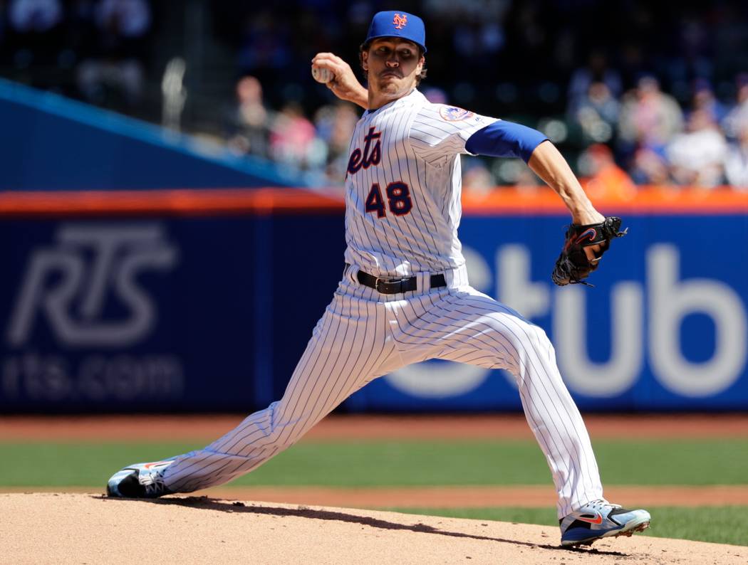 New York Mets' Jacob deGrom (48) delivers a pitch during the first inning of a baseball game against the St. Louis Cardinals Saturday, March 31, 2018, in New York. (AP Photo/Frank Franklin II)
