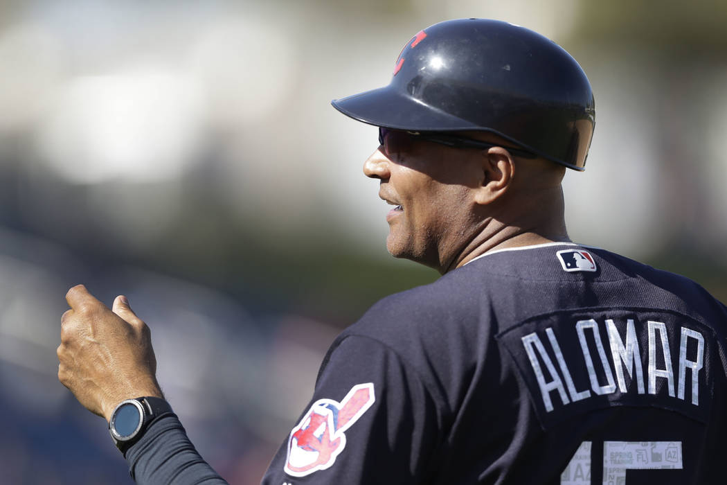 Cleveland Indians first base coach Sandy Alomar Jr. is seen during a spring training baseball game against the Milwaukee Brewers, Monday, Feb. 26, 2018, in Maryvale, Ariz. (AP Photo/Carlos Osorio)