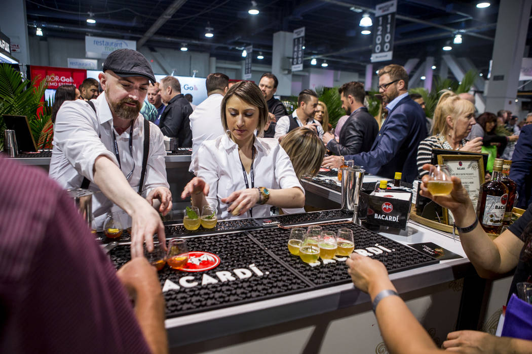 Bacardi bartenders Jimmy McGowan and Jessica Fitzmeyer serve attendees drinks during the Nightclub and Bar Show at the Las Vegas Convention Center on Tuesday, March 27, 2018.  Patrick Connolly Las ...