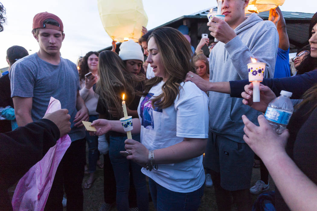 Allie Rossi, center, mourns the loss of her brother, Albert "A.J." Rossi, during a candlelight vigil at Knickerbocker Park in Las Vegas Friday, March 30, 2018. Albert "A.J." Ro ...