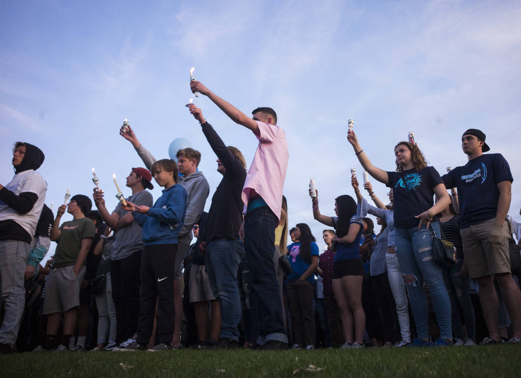 Attendees during a candlelight vigil at Knickerbocker Park in Las Vegas Friday, March 30, 2018 for Centennial High School students Albert "A.J." Rossi, Dylan Mack and Brooke Hawley, who  ...