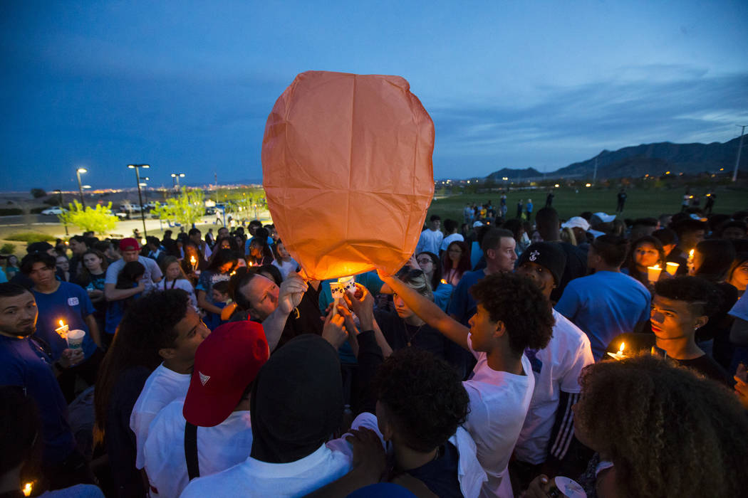 Attendees light a balloon during a candlelight vigil at Knickerbocker Park in Las Vegas Friday, March 30, 2018 for Centennial High School students Albert "A.J." Rossi, Dylan Mack and Bro ...