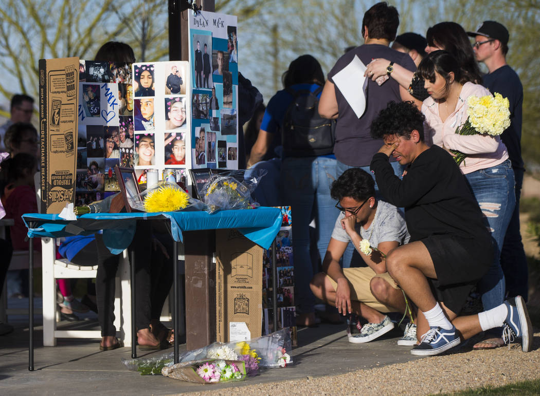 Jesus Vargas, far right, mourns during a candlelight vigil at Knickerbocker Park in Las Vegas Friday, March 30, 2018. Centennial High School students Albert "A.J." Rossi, Dylan Mack and  ...