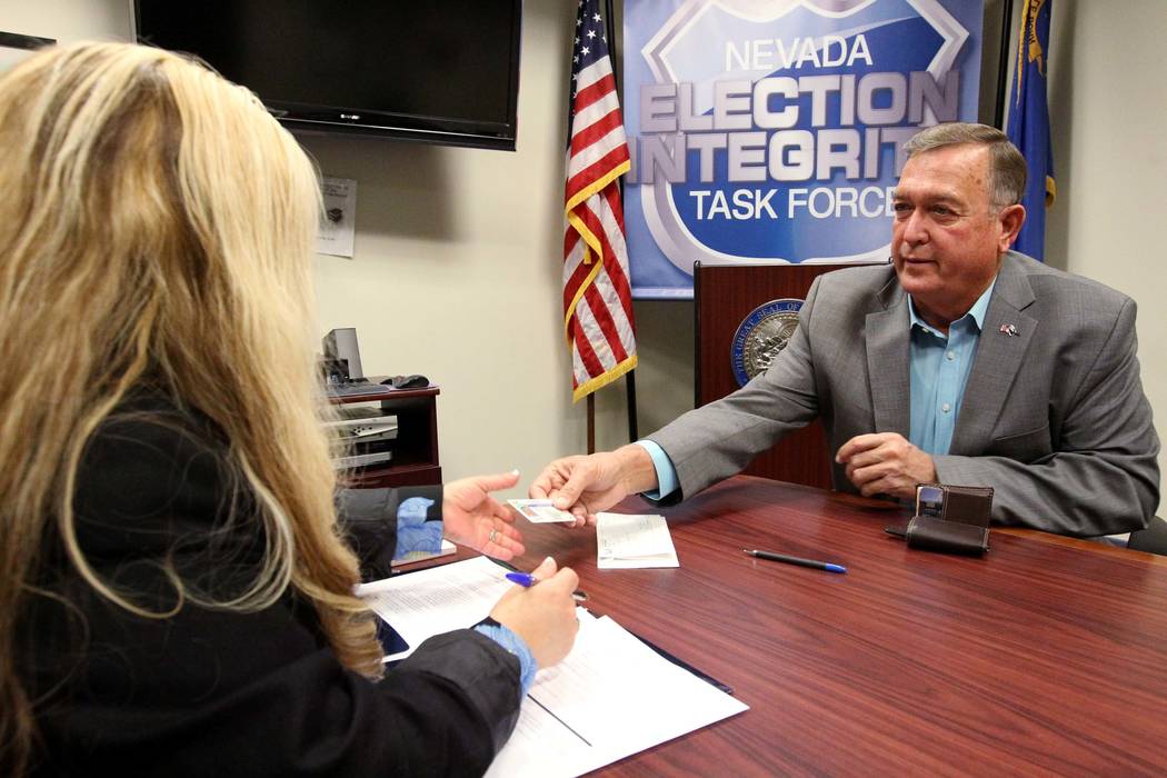 Former Nevada Rep. Cresent Hardy, right, files to run for his old Congressional District 4 seat with Irene Jimenez-Muir at the Secretary of State Las Vegas office Monday, March 5, 2018. (K.M. Can ...