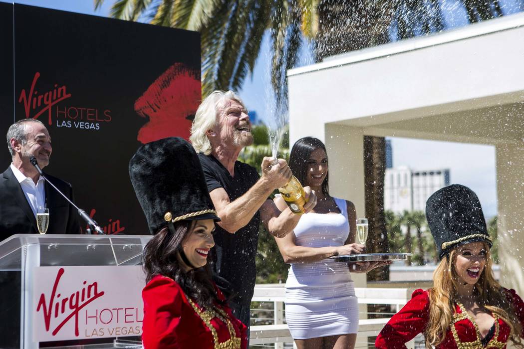 Virgin Group Founder Sir Richard Branson pops a champagne bottle following a press conference at the Hard Rock Hotel in Las Vegas on Friday, March 30, 2018.  Patrick Connolly Las Vegas Review-Jour ...