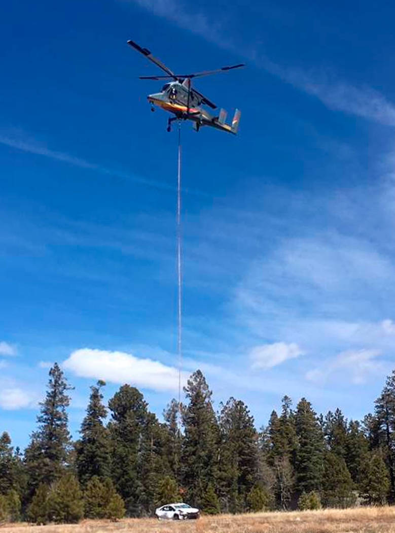 A helicopter removes a vehicle from below the North Rim of the Grand Canyon in Arizona on Thursday. (National Park Service via AP)