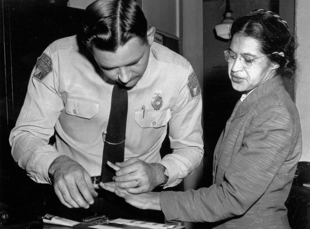 FILE - In this Feb. 22, 1956, file photo, Rosa Parks is fingerprinted by police Lt. D.H. Lackey in Montgomery, Ala., two months after refusing to give up her seat on a bus for a white passenger on ...