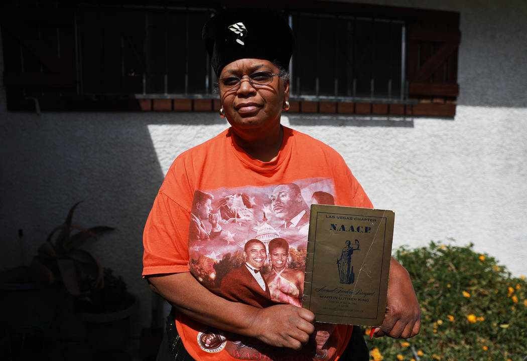 Gwen Walker, owner of the Walker African-American Museum & Research Center, poses for a photograph with a program from the Las Vegas chapter's NAACP Freedom Banquet in 1964, which featured Dr. ...