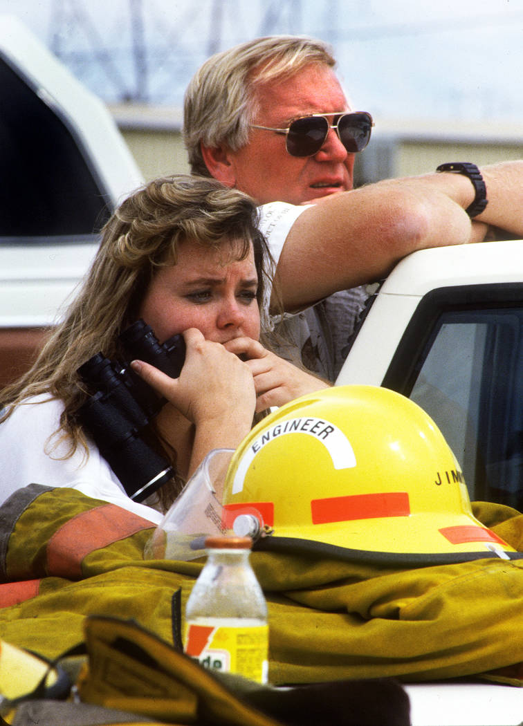 Kendra Brown and Pat Hinds watch the scene at the PEPCON plant in Henderson on May 4, 1988, after a fire and explosion rocked the Las Vegas Valley. Their business, Unicorn Sailing Center, located ...