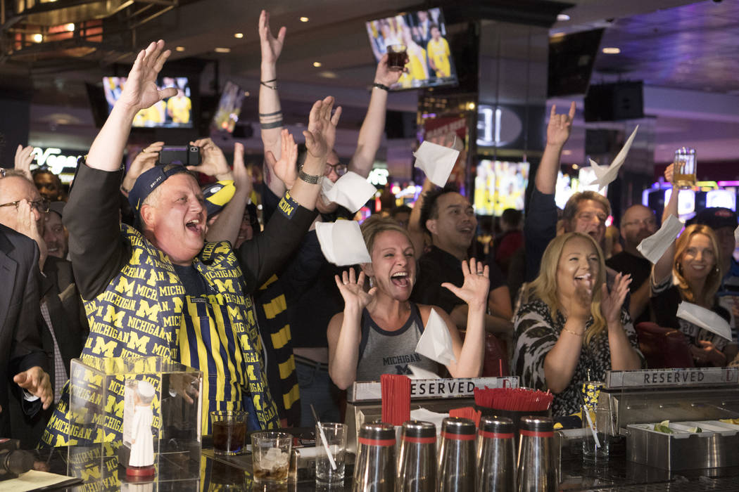 Derek Stevens, CEO and co-owner of The D Las Vegas, reacts along with his wife Nicole, center, and daughter Whitney while watching his alma mater Michigan take on Loyola in the Final Four Saturday ...
